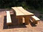 The second banquet table positioned in the sun, enbedded in an area of red gravel, with a golden hue because the sun was beating