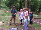 A small croud of local people gather around the artist, who happily explains the work