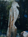 Side elevation of an Eagle sitting on a log