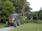 Big Blue tractor works alongside a massive crane to clear up a felled tree