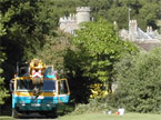 The crane fills the road upon which it is parked, seemingly as large as the Castle Tower in the background