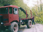 Large AC Matador vehicle side view partially loaded with timber