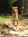 A lkarge roughly 14 inches square stand composed of 3 hollow boxes with a bowl on the top, photographed from the side